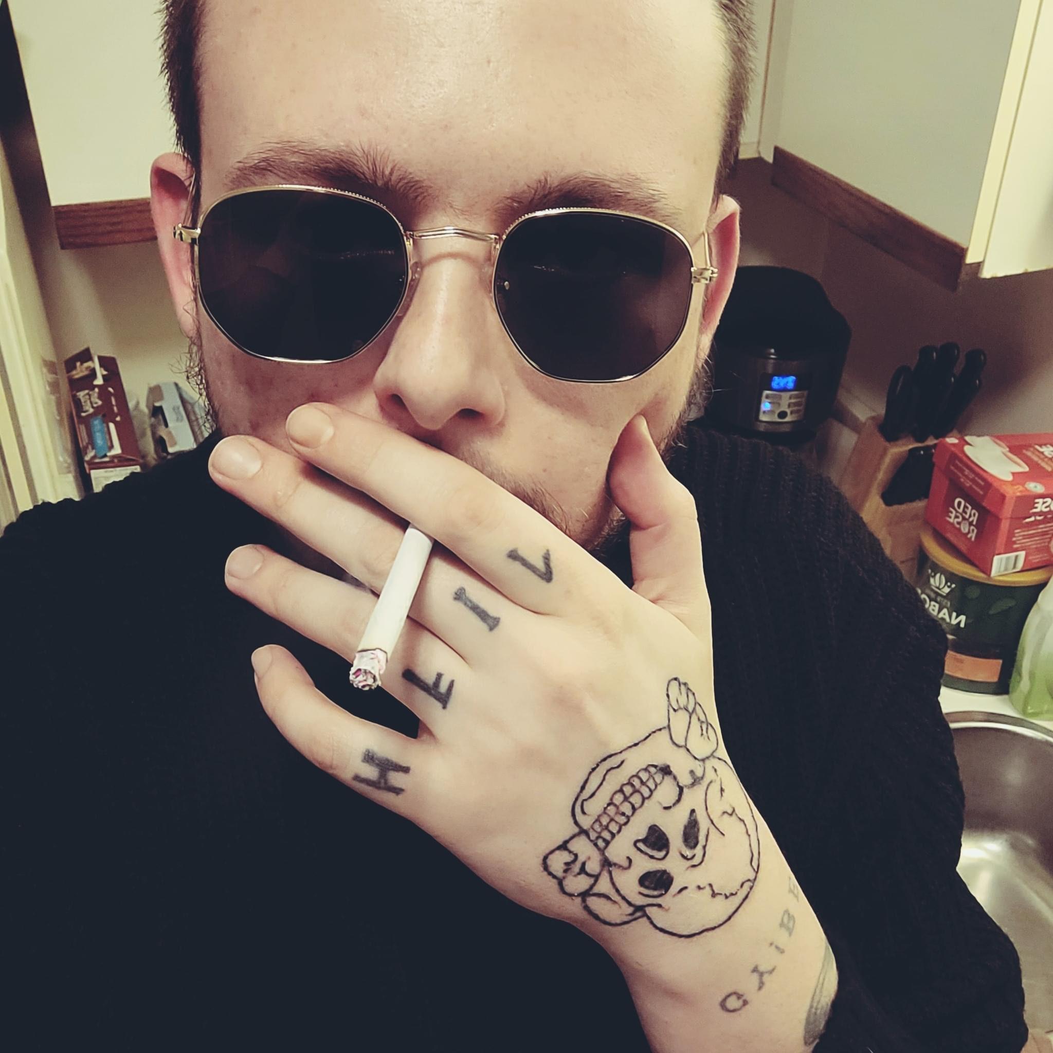 Steven Barker tattoos on his hand, a Totenkopf and “Heil”