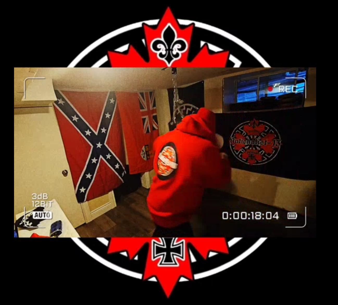 Brandon Lapointe in a Nationalist-13 video in his basement with a Sonnerad flag and Confederate flag and Nationalist-13 flag